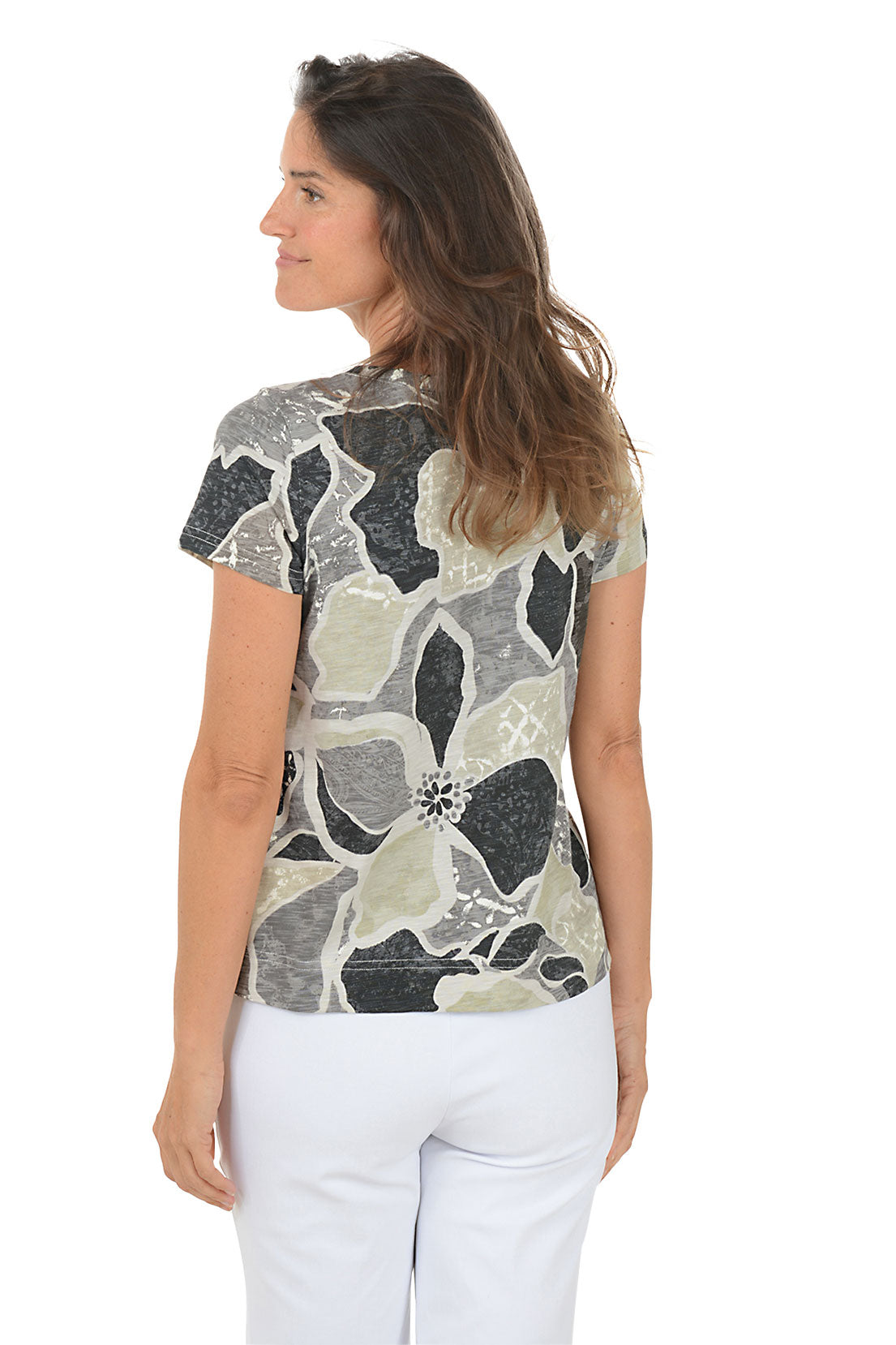 Woman wearing a floral patterned shirt on a white background. Back shot.