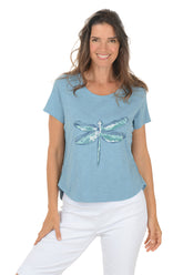 Woman wearing a blue t-shirt with a dragonfly design on a white background.
