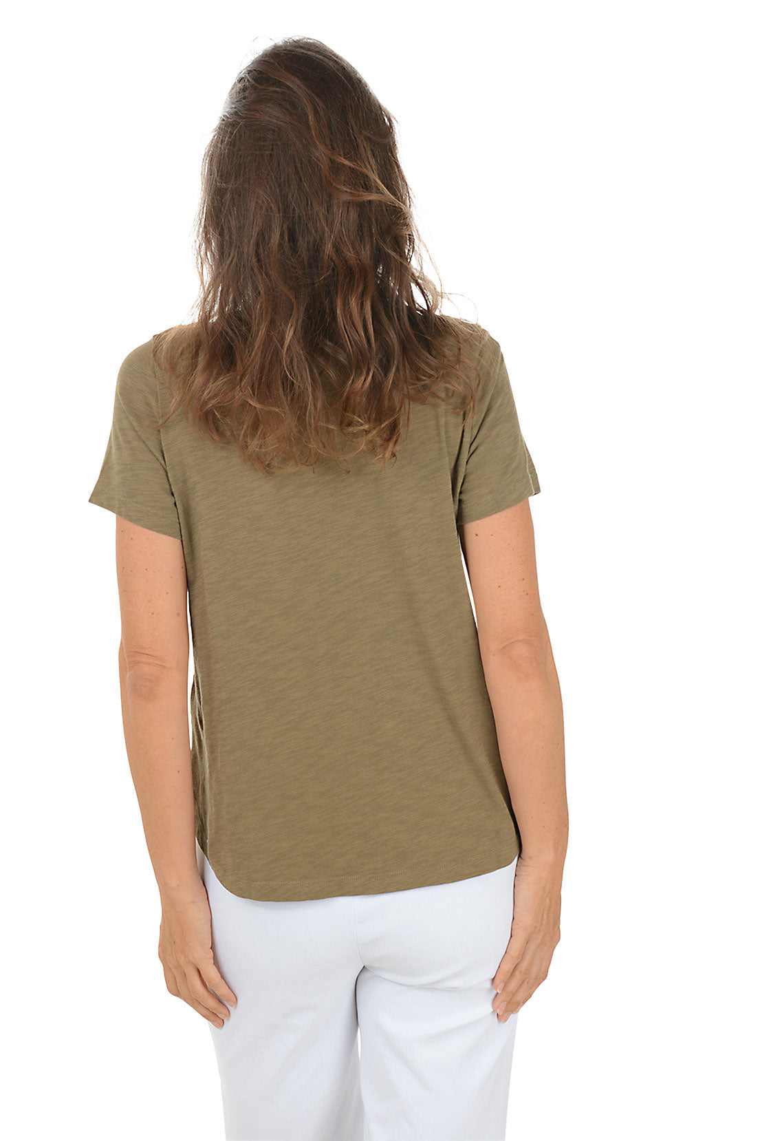 Woman wearing a green t-shirt with a pink floral design on a white background. Back shot.
