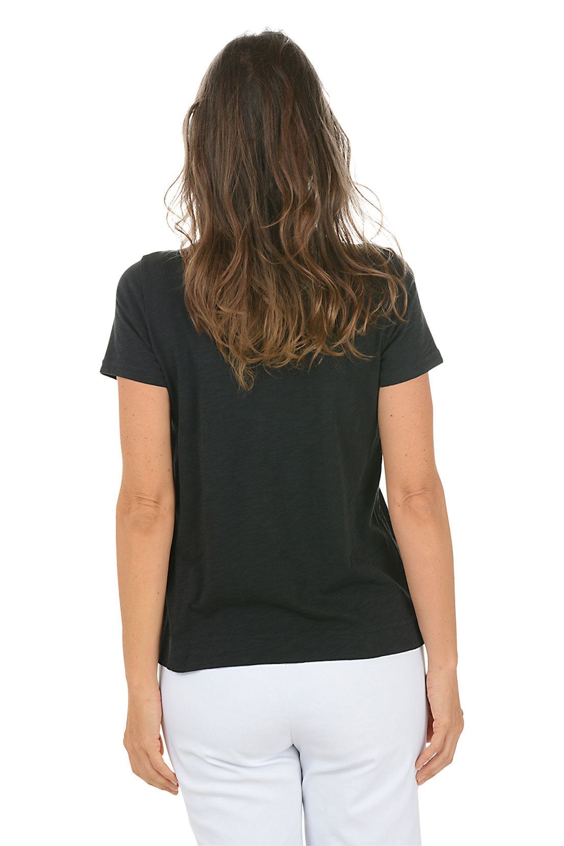 Woman wearing a black t-shirt with a floral design on a white background. Back shot.