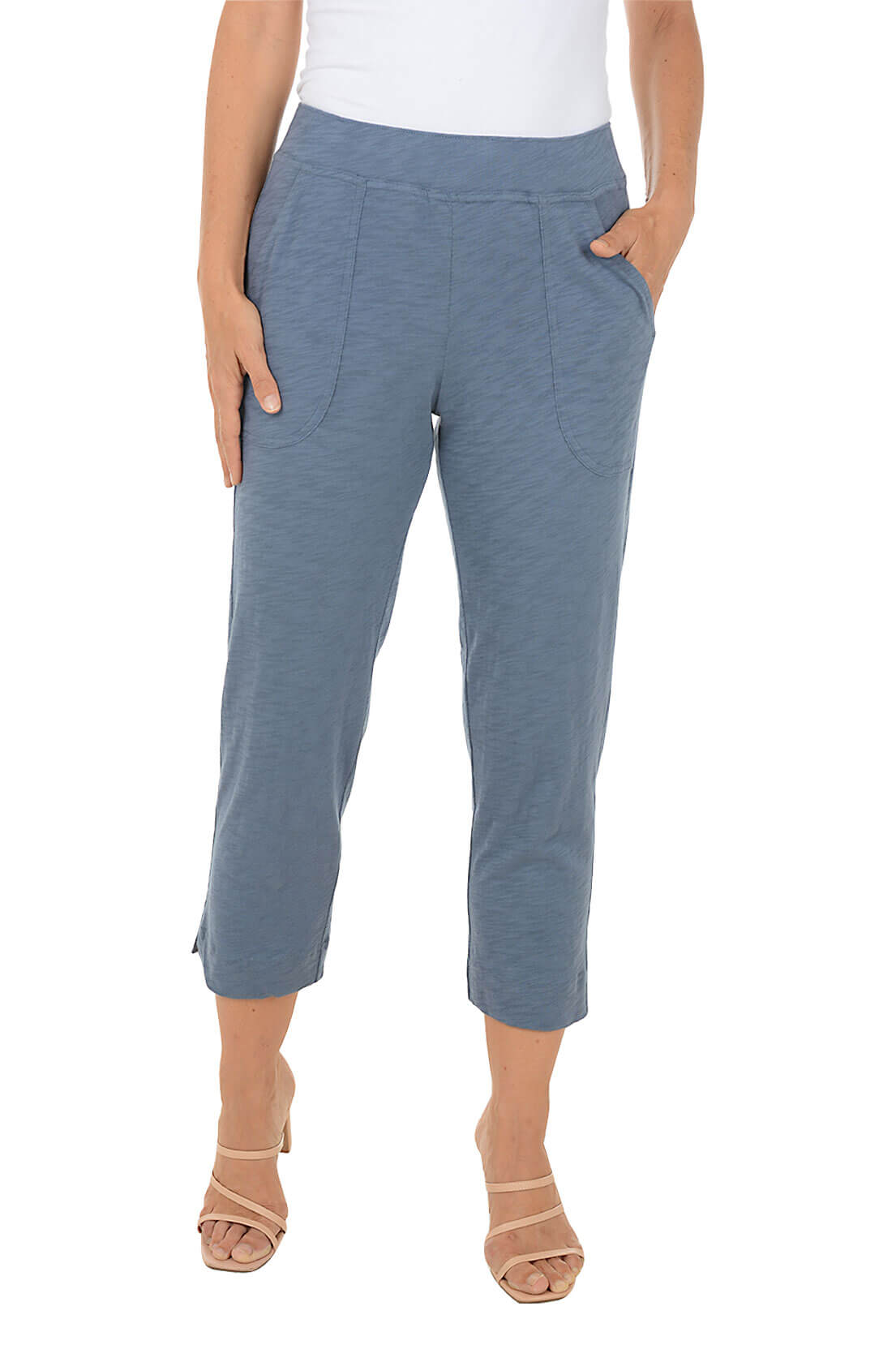 Blue pants worn by a person on a white background