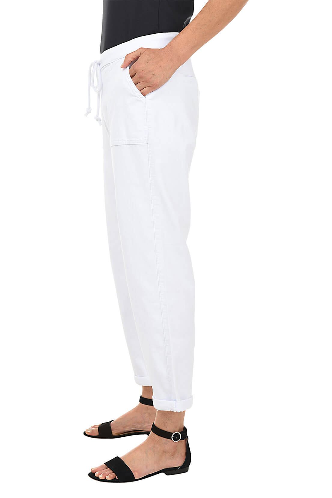 White pants worn by a person on a white background. Side shot.