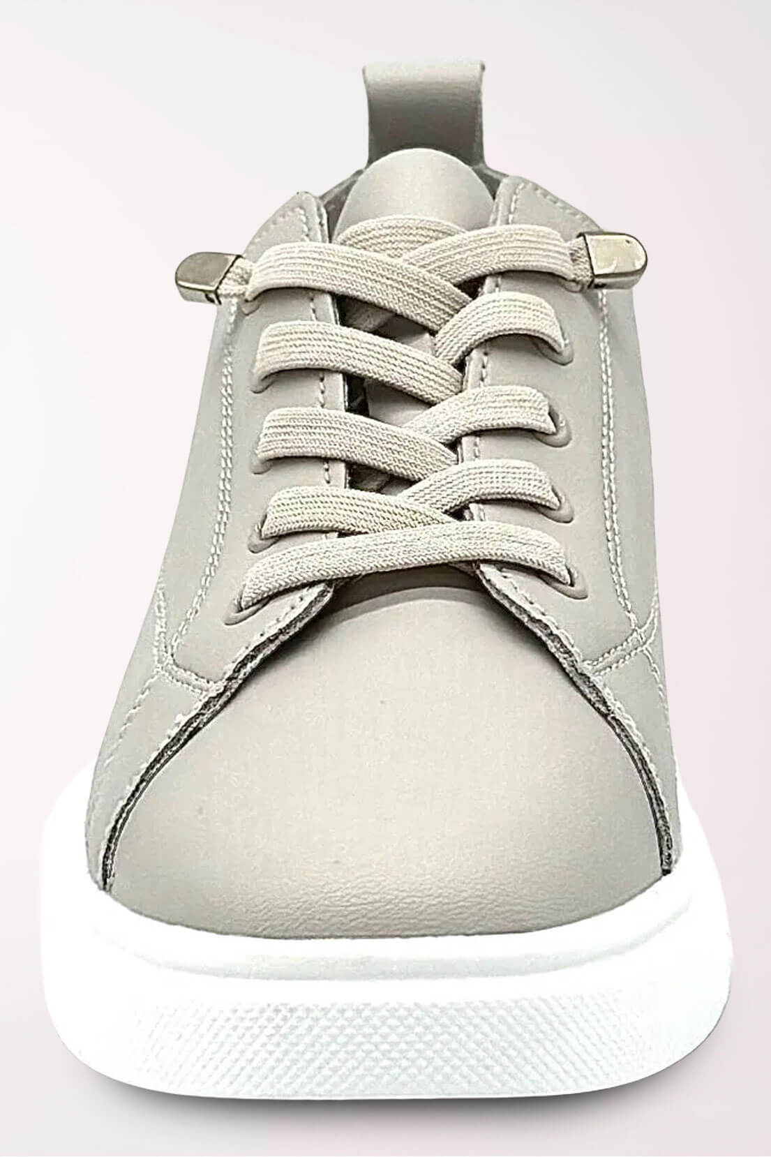 Front view of the taupe Paros sneaker showing the elastic laces with rhinestone tips and rounded toe.