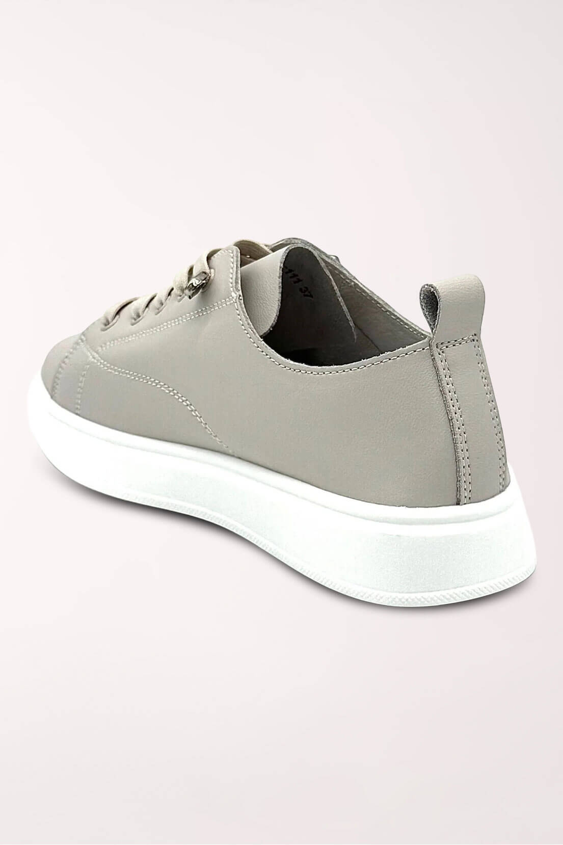 Back angle of the taupe Paros sneaker showing the heel tab and slim white sole.