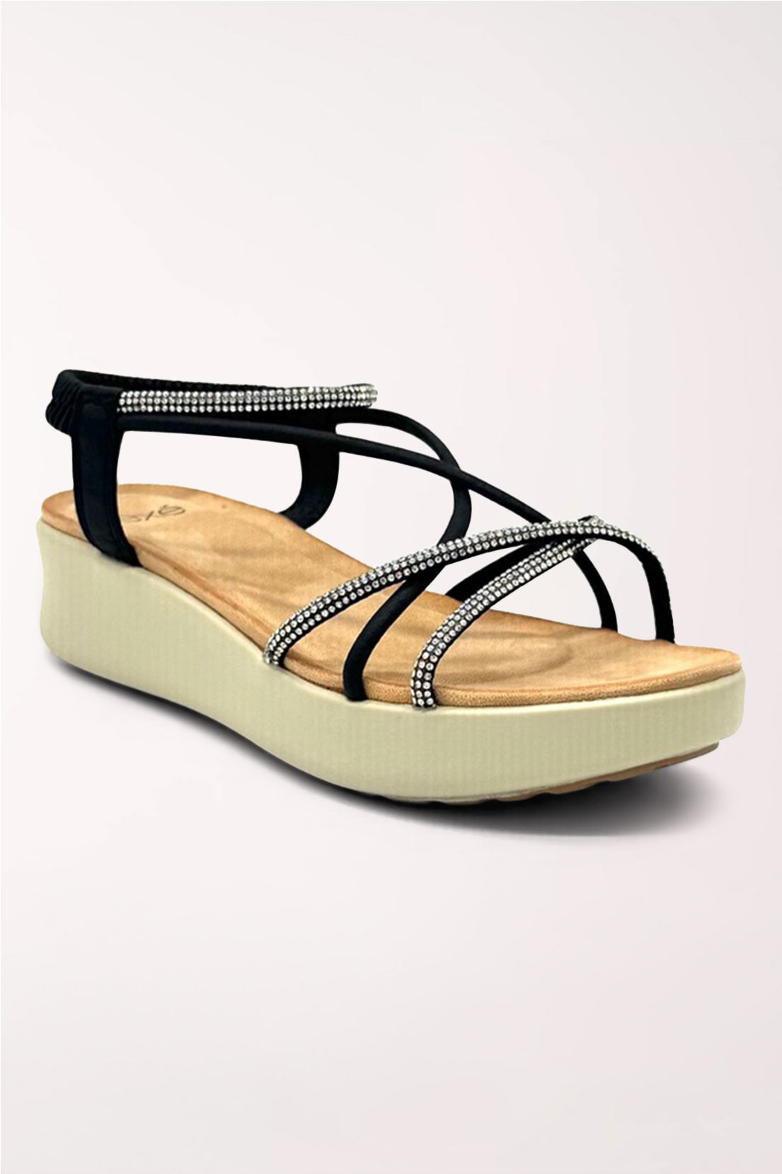 Black strappy wedge sandal with crisscrossing elastic straps trimmed in rhinestones, a slingback ankle strap, tan cushioned footbed and cream wedge sole, shown from the side.