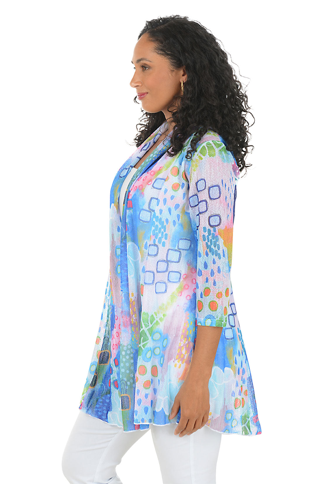 Woman wearing a colorful patterned jacket on a white background. Side shot.