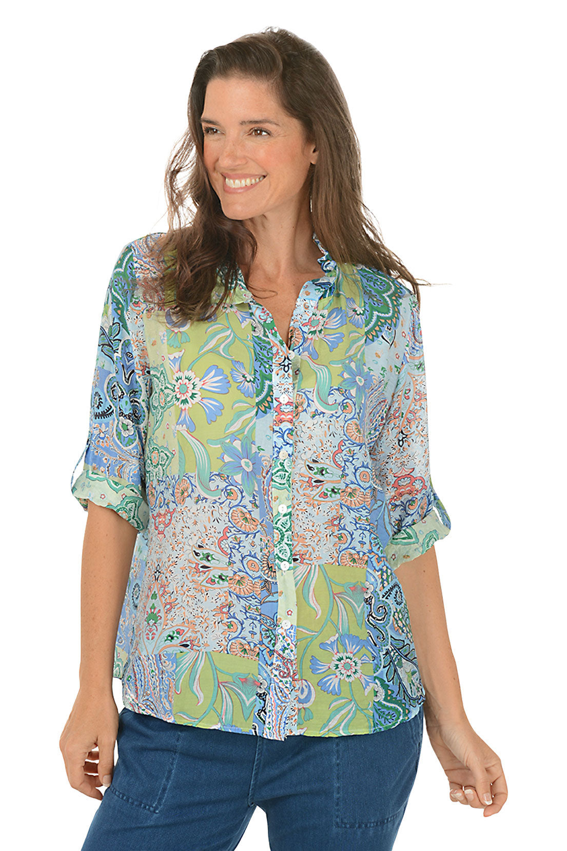 Woman wearing a colorful patterned shirt on a white background.
