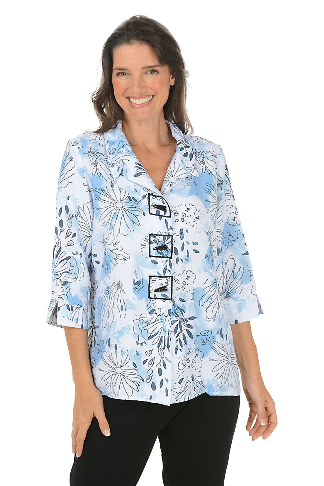Woman wearing a floral patterned shirt on a white background.