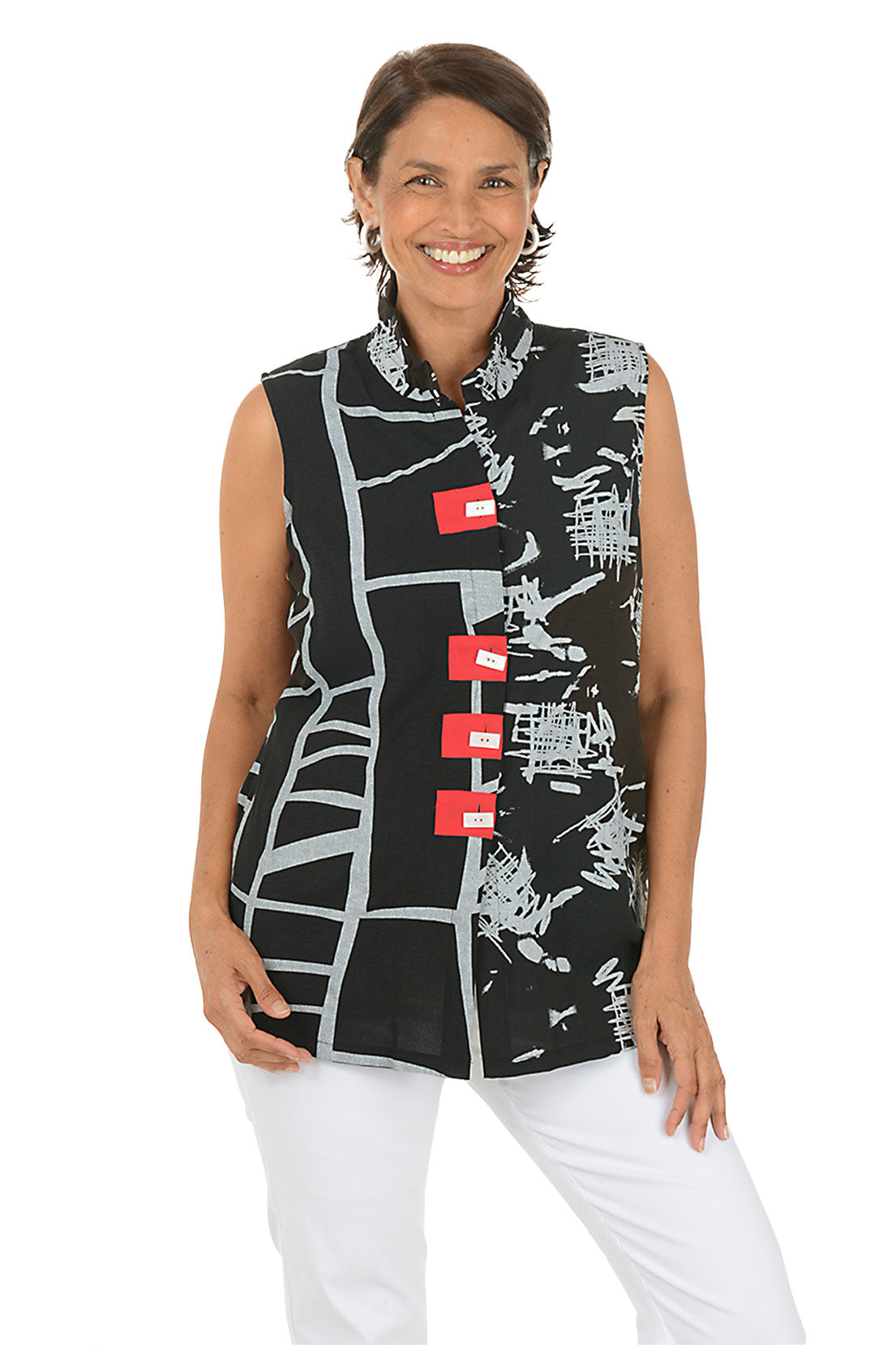 Woman wearing a sleeveless black top with white and red patterns on a white background.