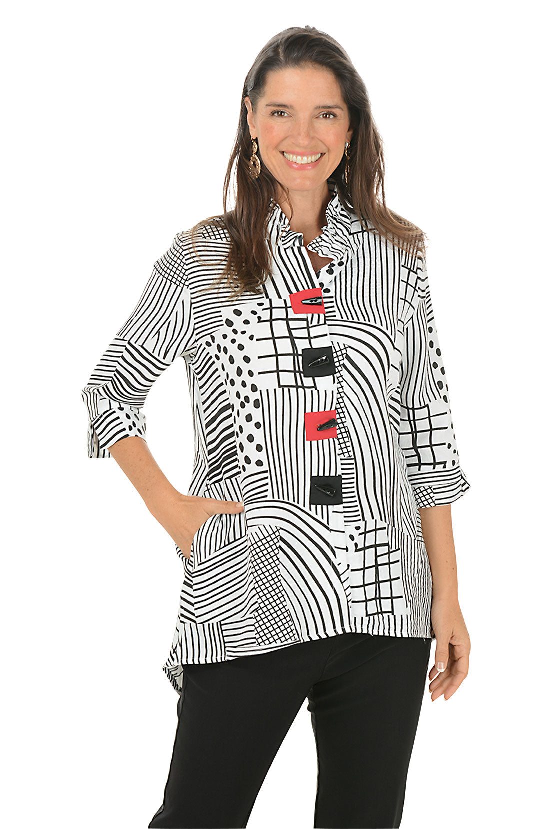 Woman wearing a black and white patterned blouse with red accents on a white background.