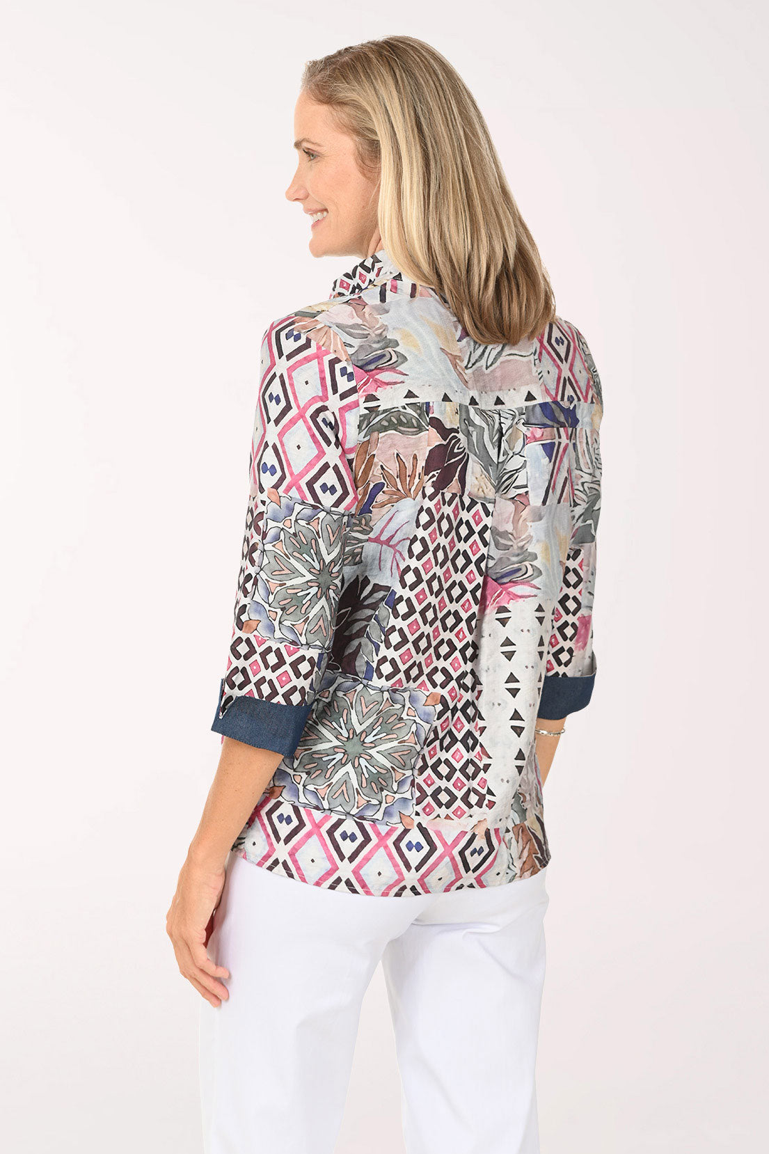Woman wearing a multi colored button down top with 3/4 sleeves