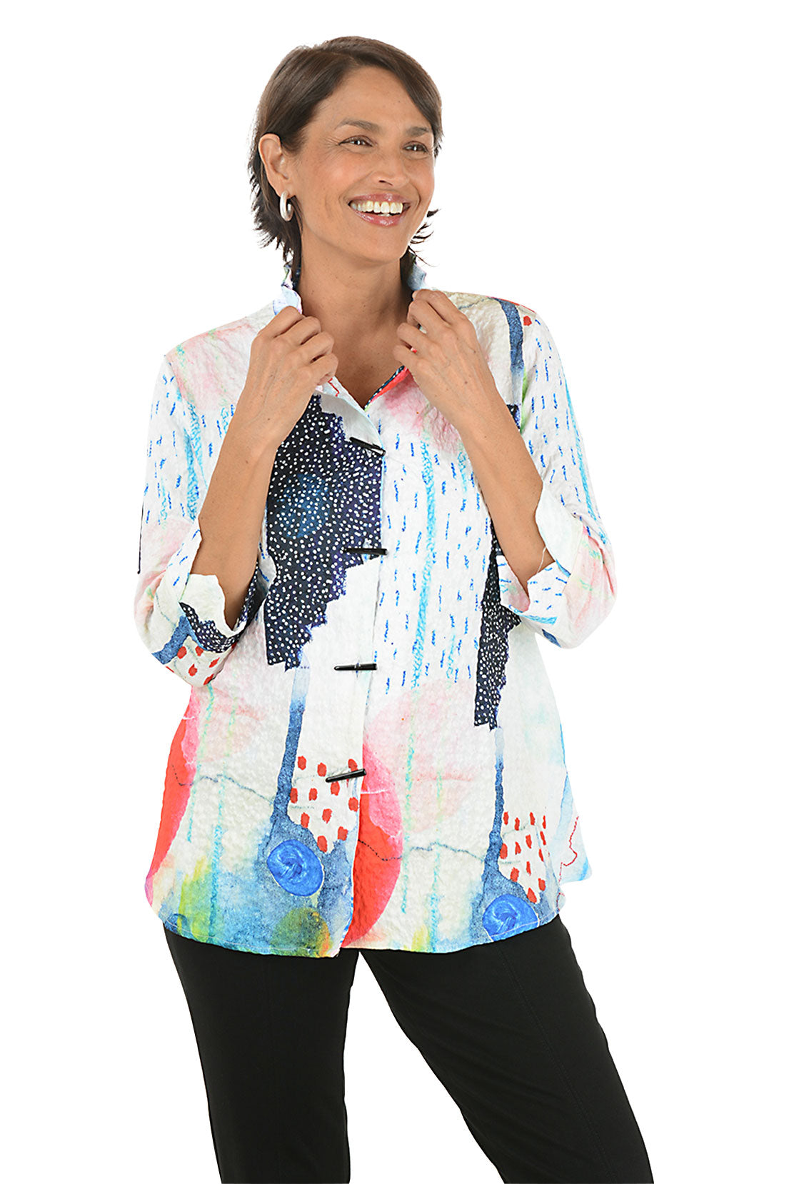 Woman wearing a colorful patterned blouse on a white background.