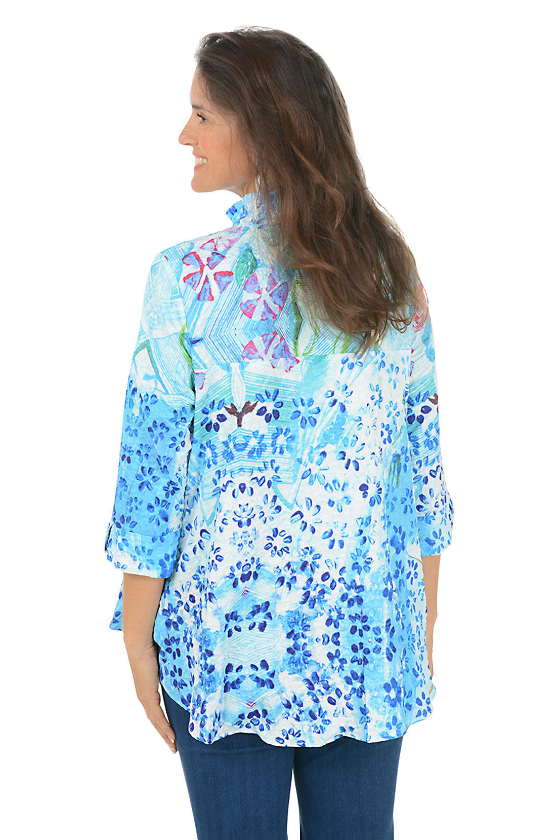 Woman wearing a blue floral patterned shirt on a white background. Back shot.