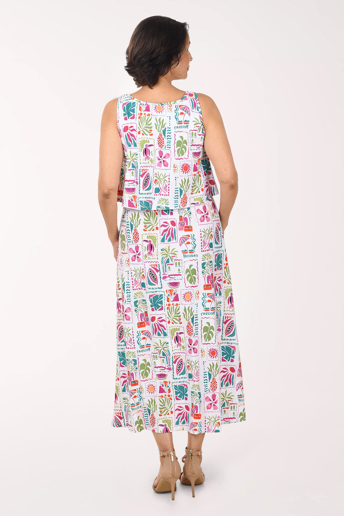 Woman wearing a colorful patterned dress on a white background