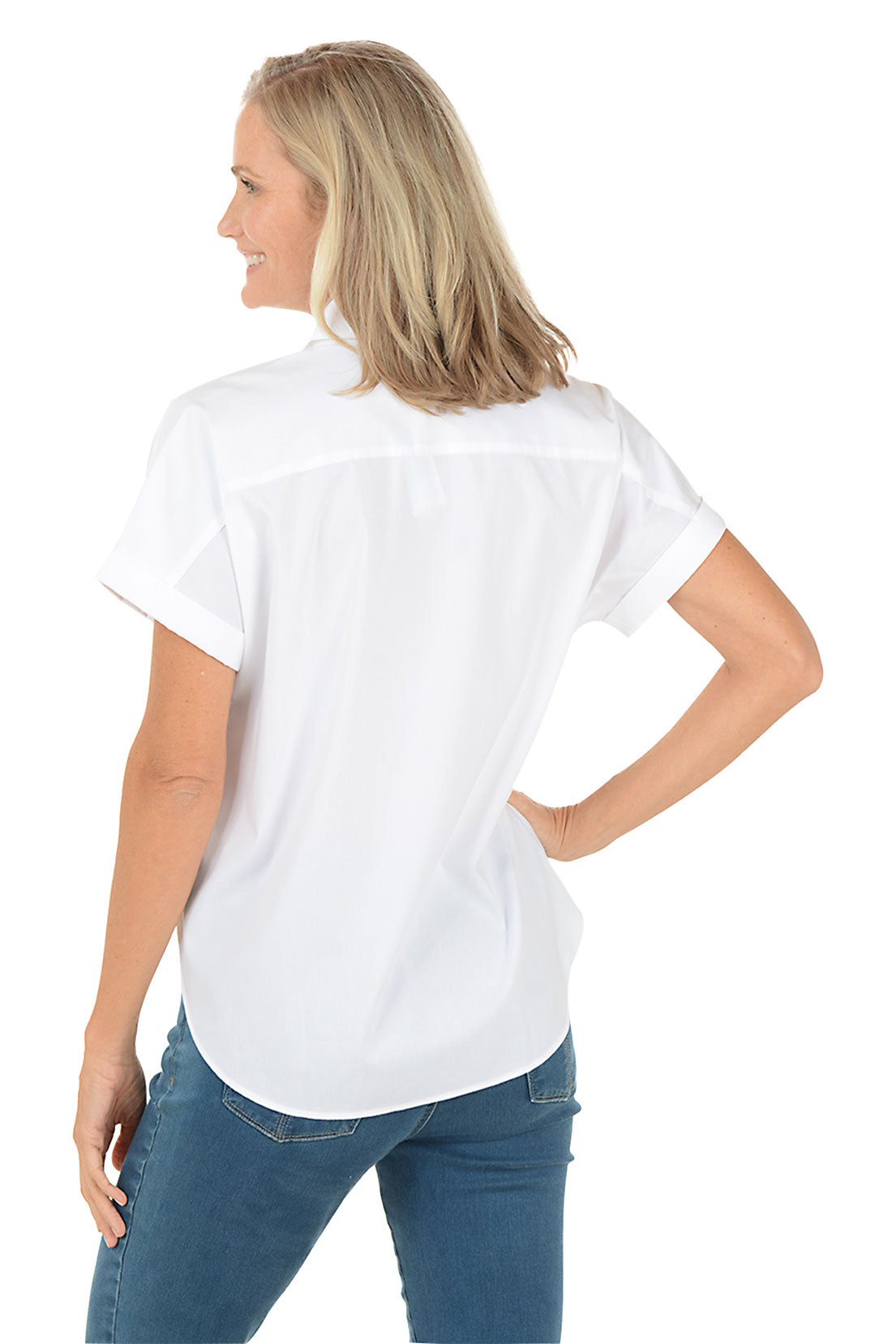 Woman wearing a white button-up shirt and blue jeans on a white background. Back shot.