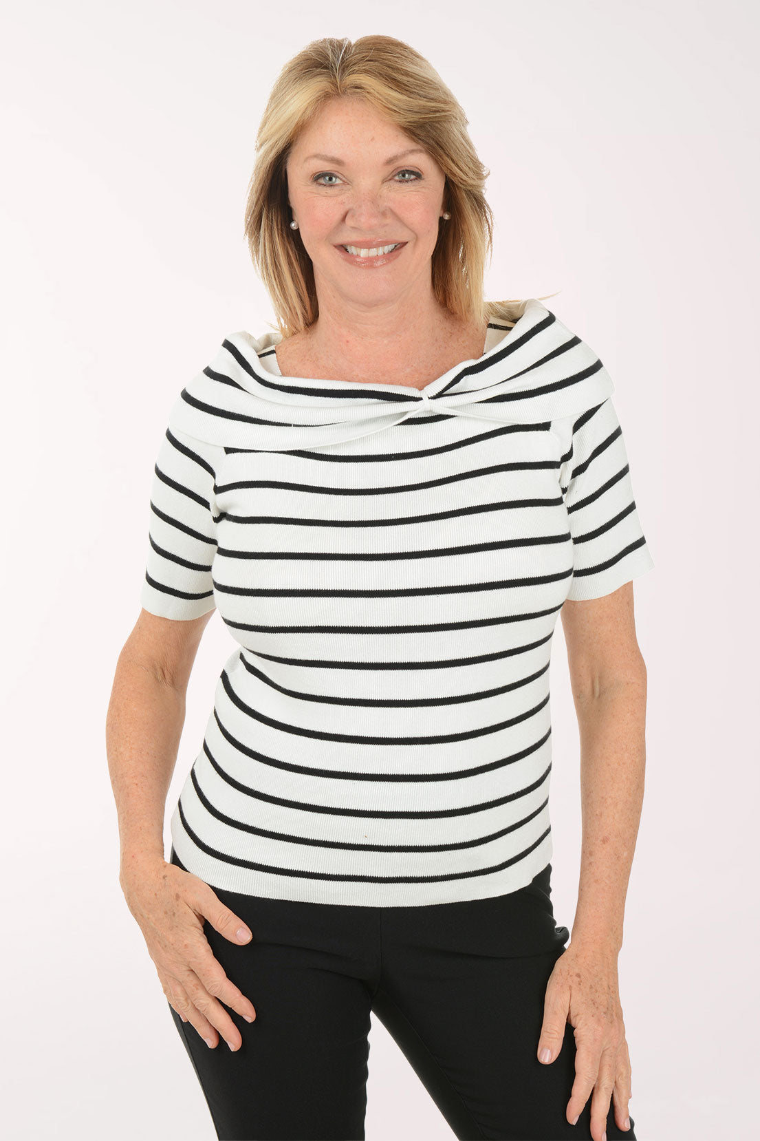 Woman wearing a black and white striped shirt against a white background