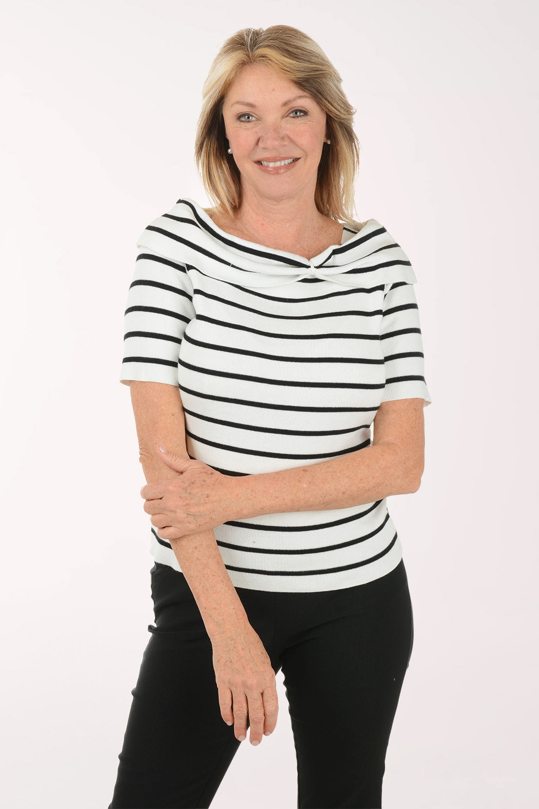 Woman wearing a black and white striped shirt against a white background
