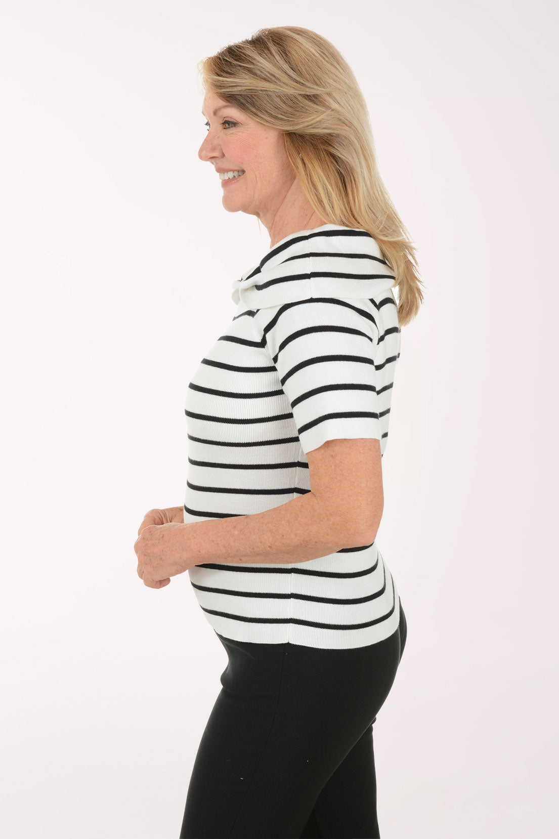 Woman wearing a black and white striped shirt against a white background