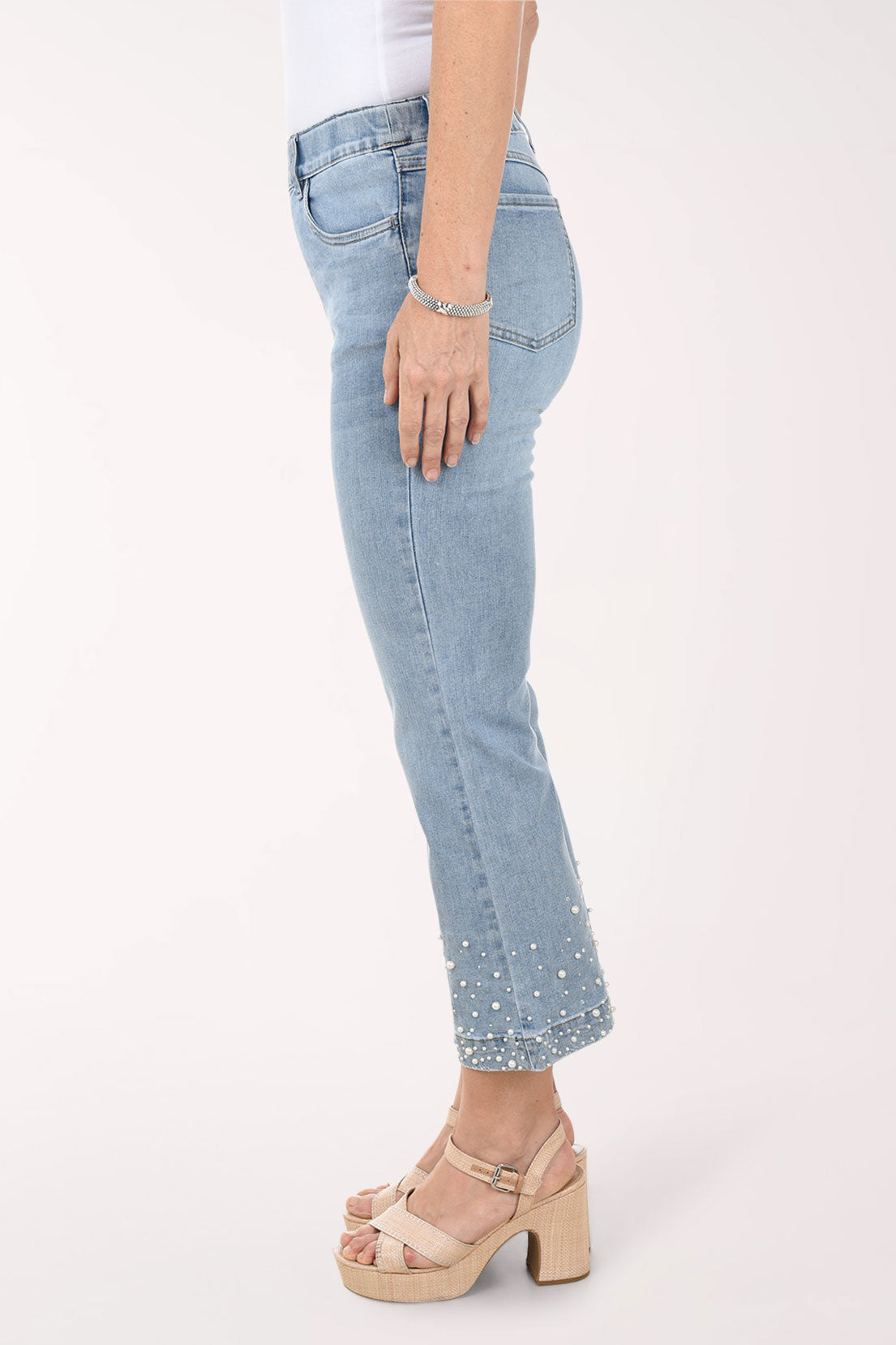 Light blue jeans worn by a person on a white background