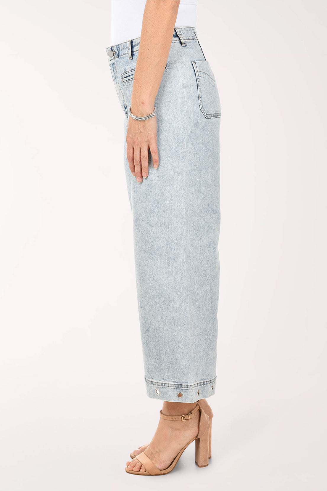 Light blue jeans worn by a person on a white background