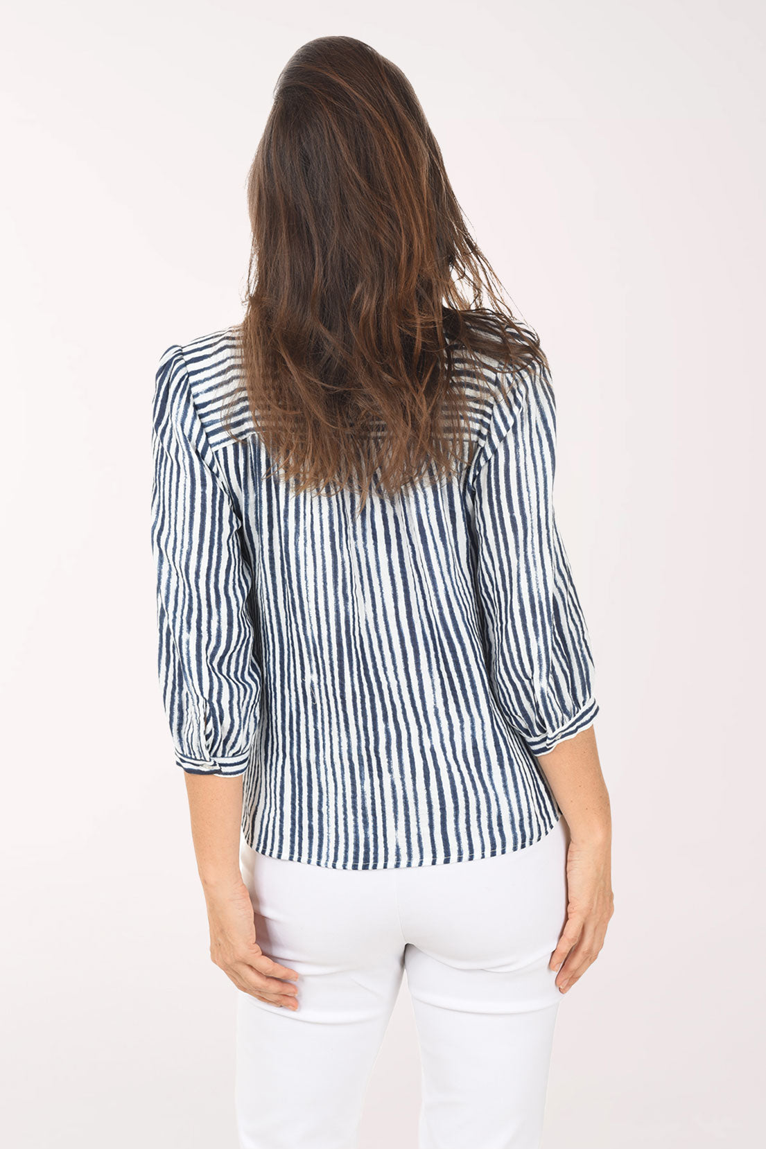 Woman wearing a blue and white striped shirt on a white background