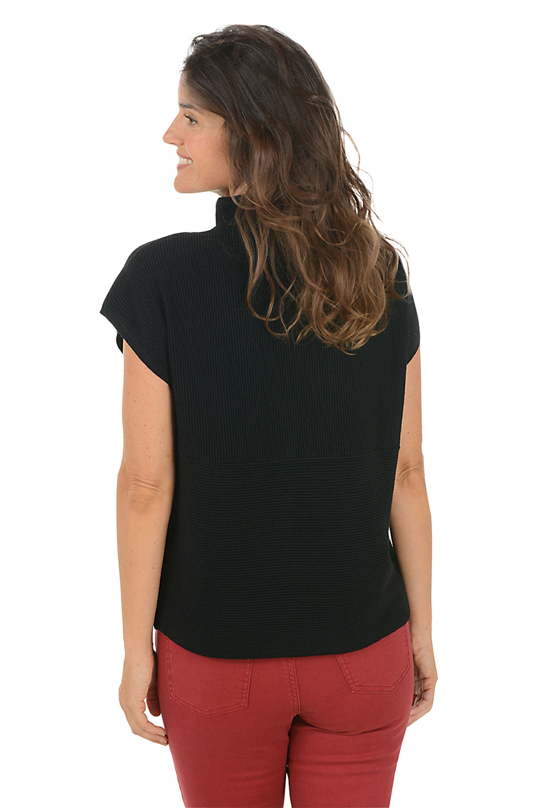 Woman wearing a black sleeveless top and red pants on a white background. Back shot.