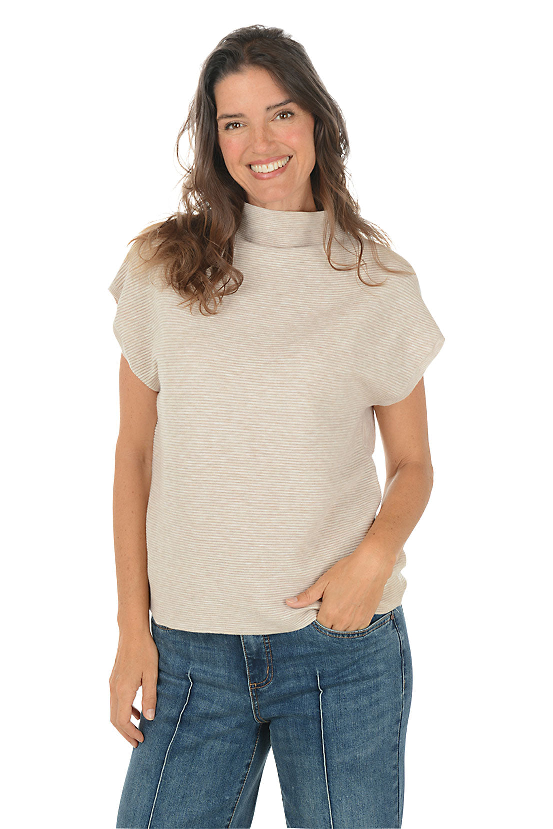 Woman wearing a beige sleeveless top and denim pants on a white background.