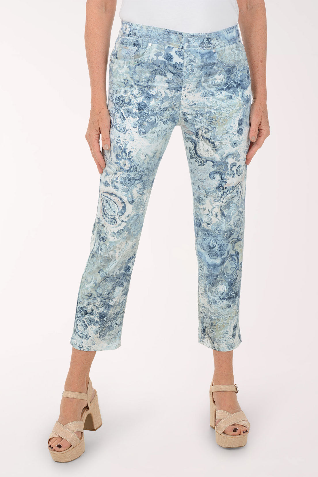 Person wearing blue patterned pants on a white background