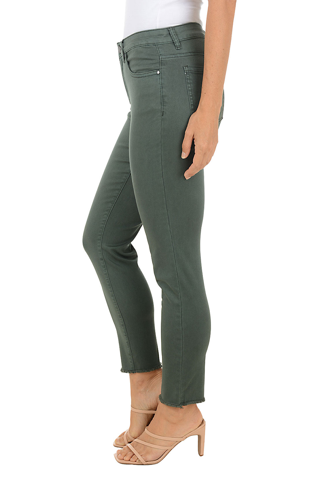 Person wearing green ankle jeans on a white background. Side shot.