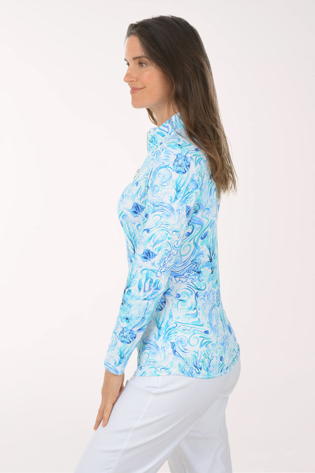 Woman wearing a blue floral long-sleeve shirt on a white background