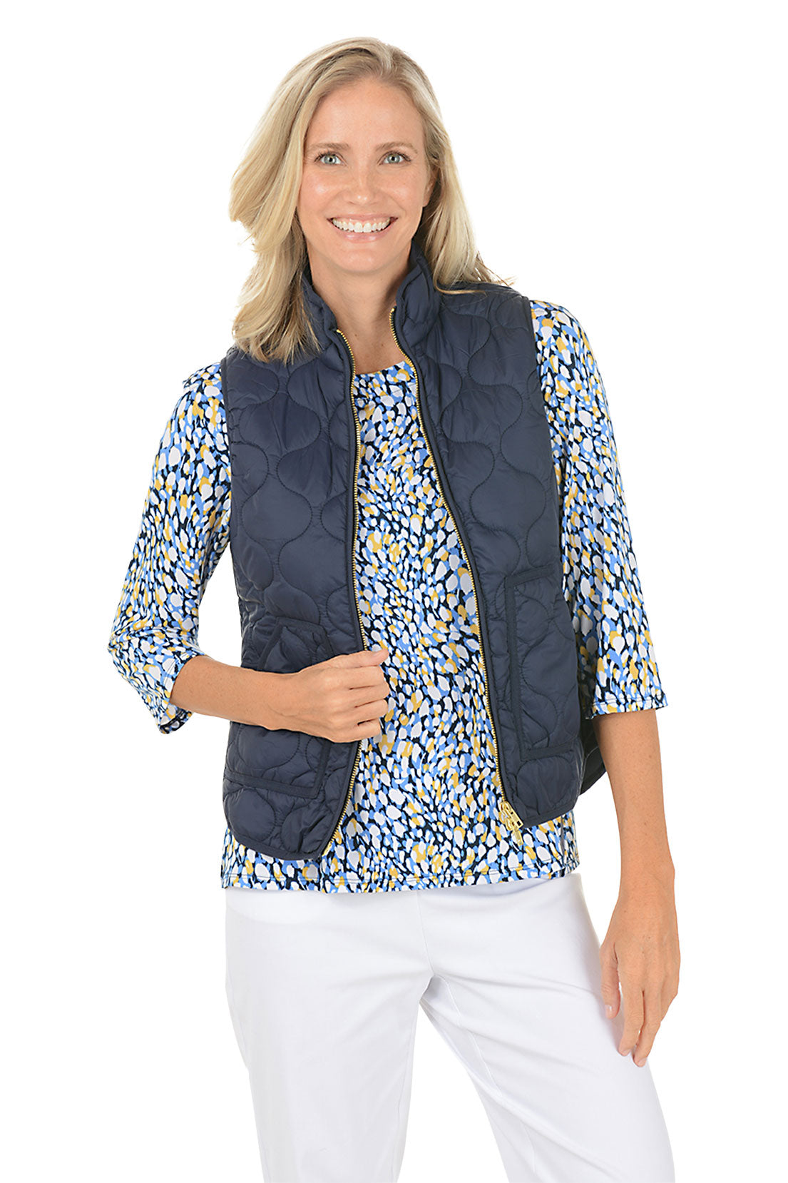 Woman wearing a navy quilted puffer vest.