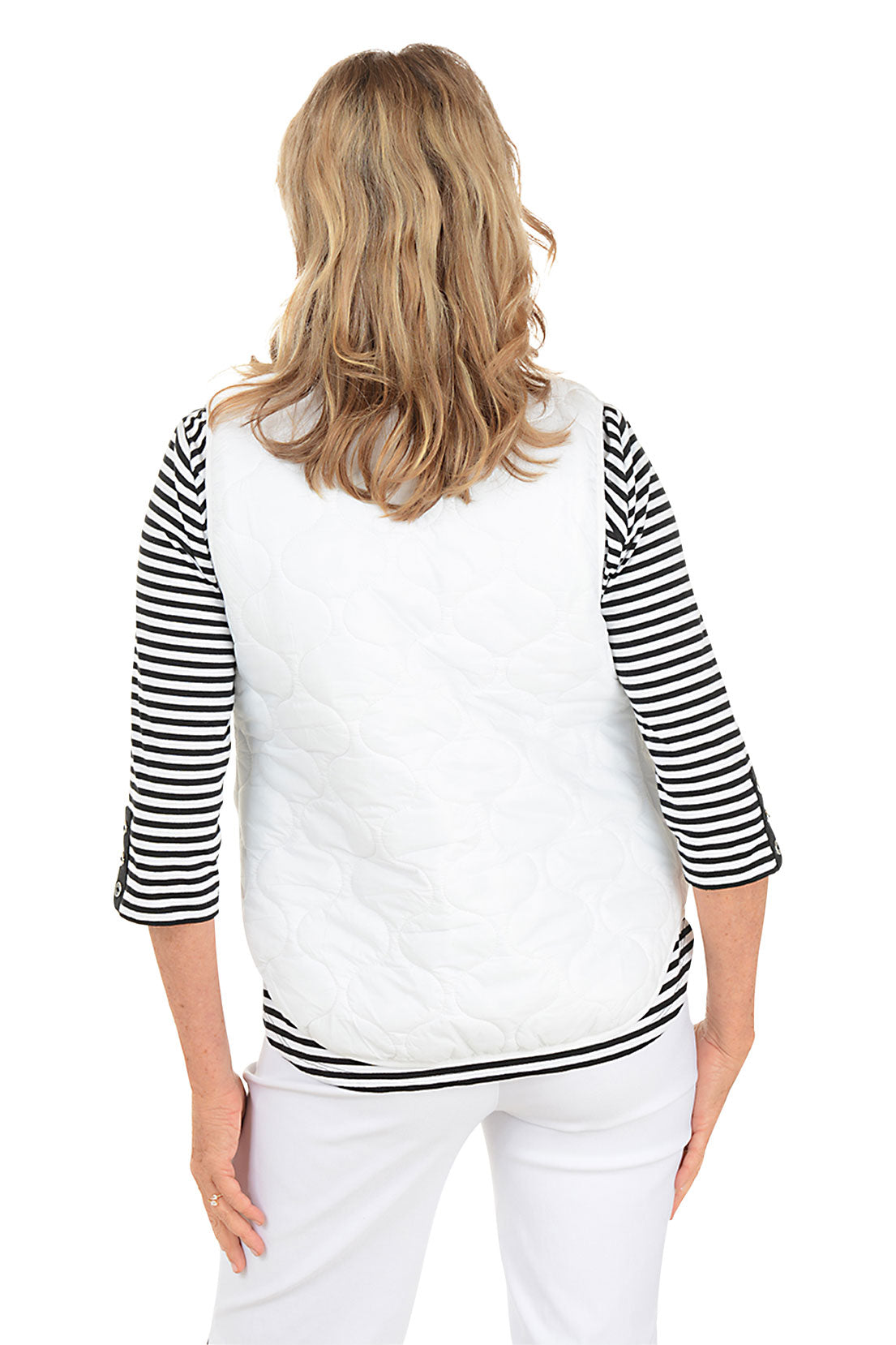 Woman wearing a white quilted puffer vest. Back shot.