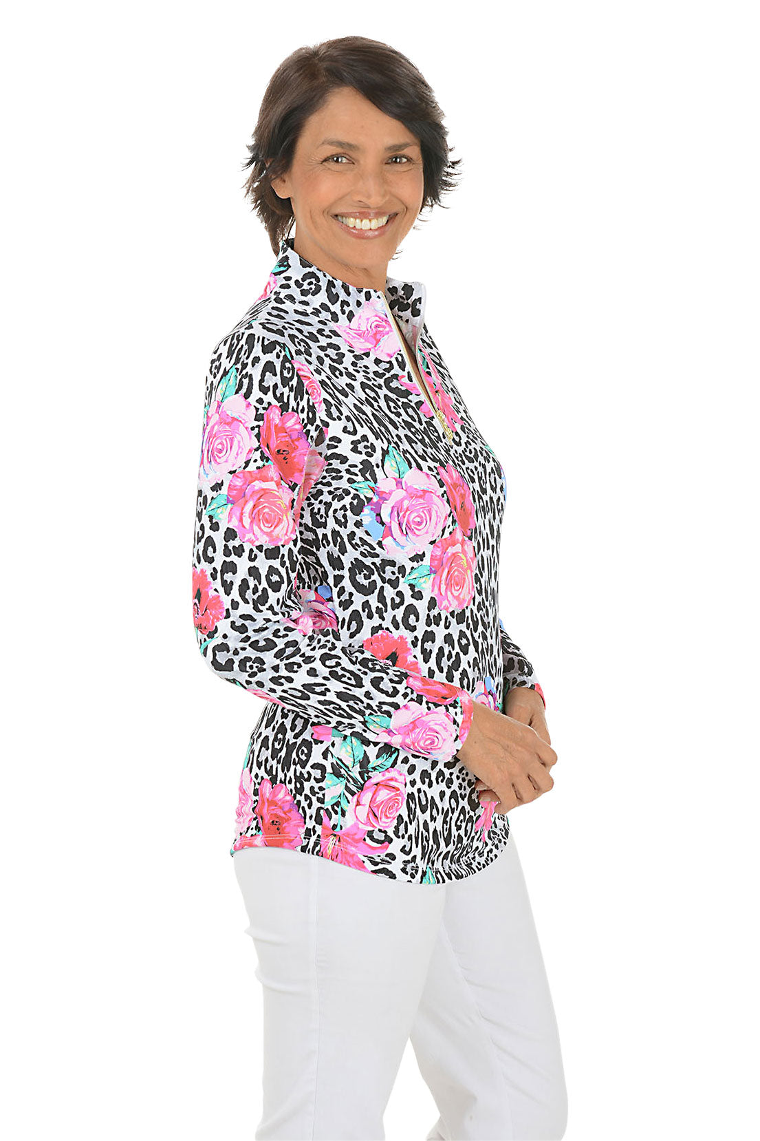 Woman wearing a colorful floral and leopard print top on a white background. Side shot.
