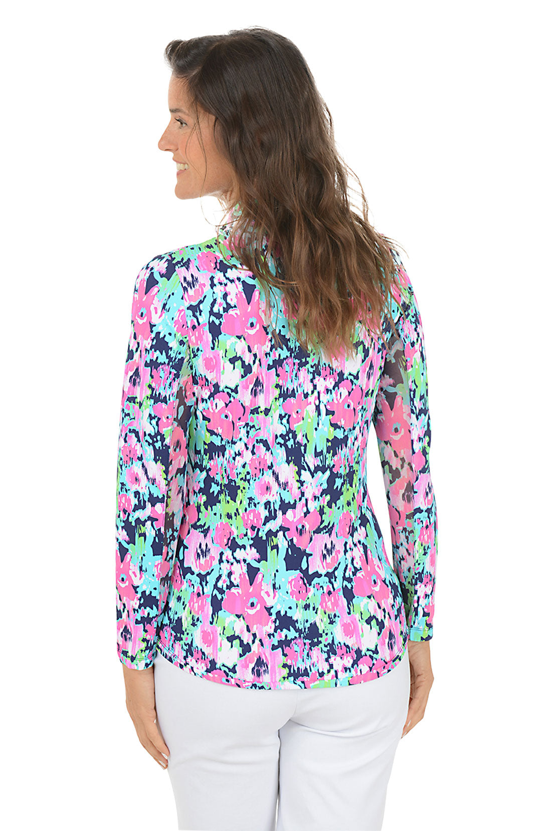 Woman wearing a colorful floral blouse on a white background. Back shot.
