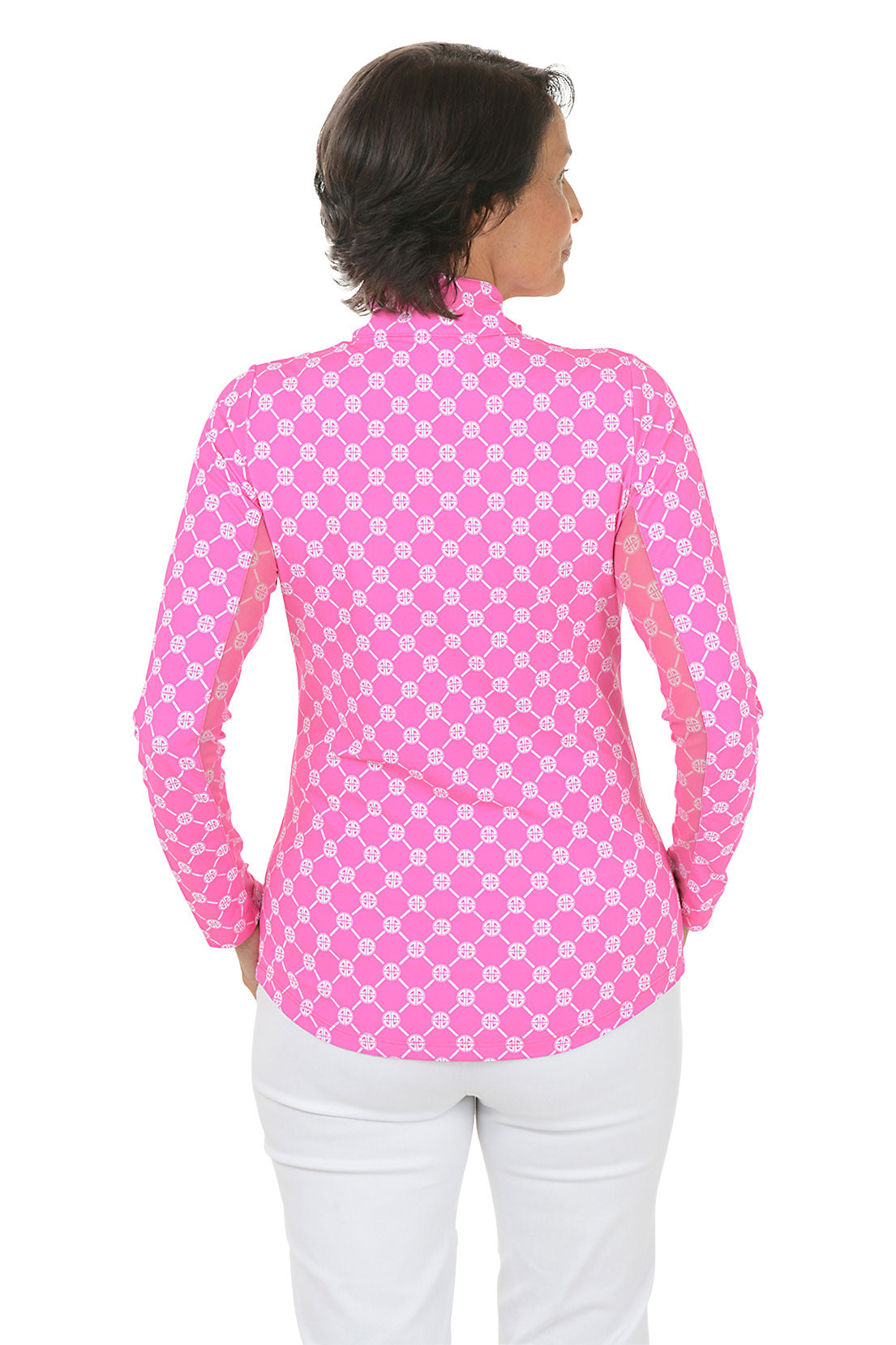Woman wearing a pink geo-patterned long-sleeve shirt with a white background. Back shot.