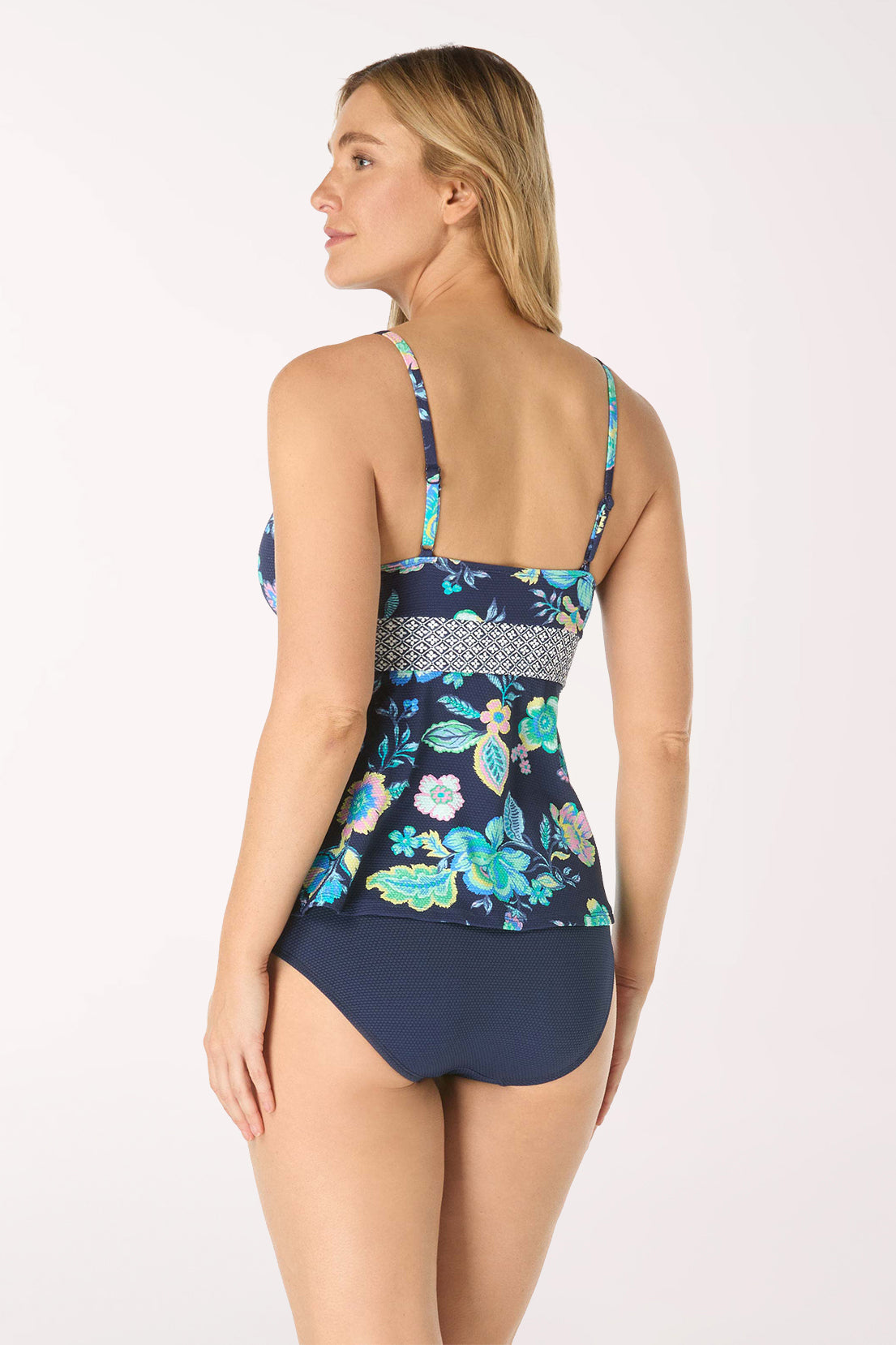 Woman wearing a floral-patterned swimsuit on a white background