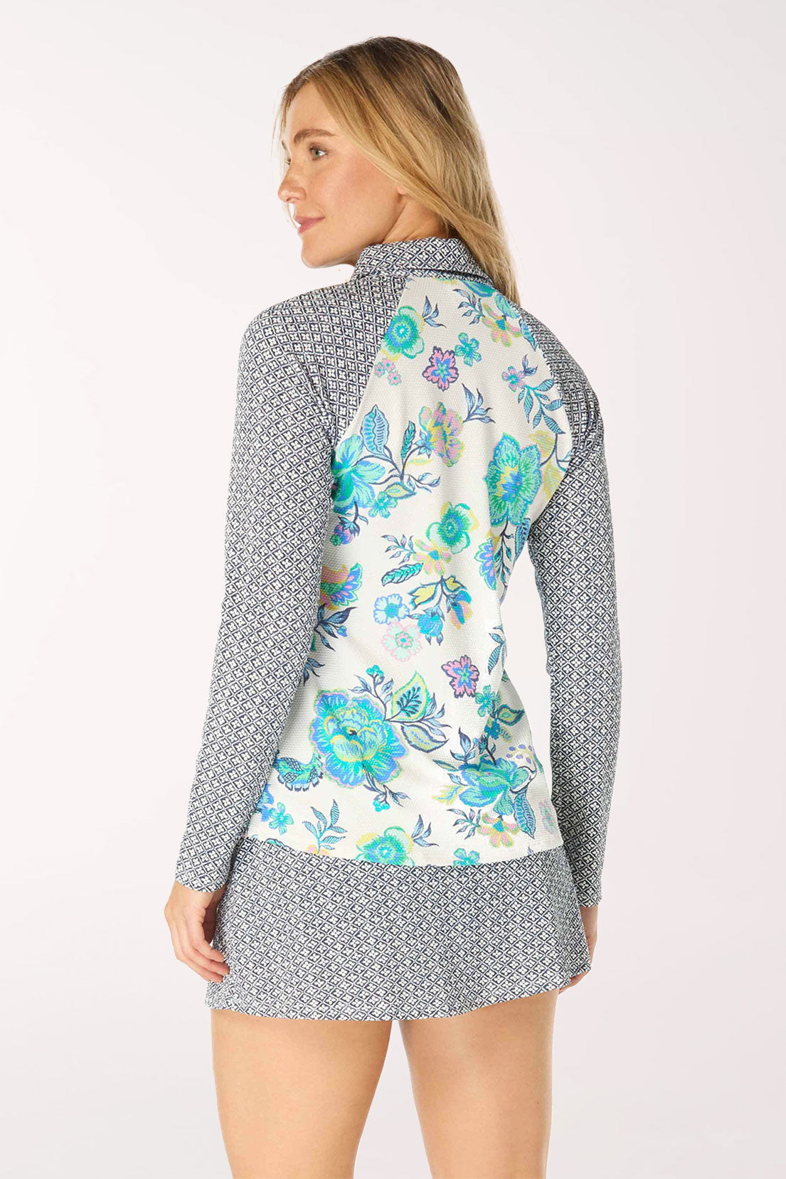 Woman wearing a floral rash guard with a patterned collar on a white background
