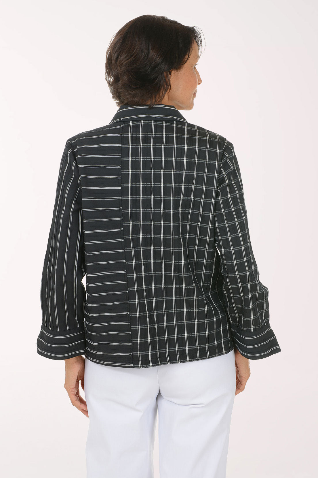 Woman wearing a black and white striped button down shirt