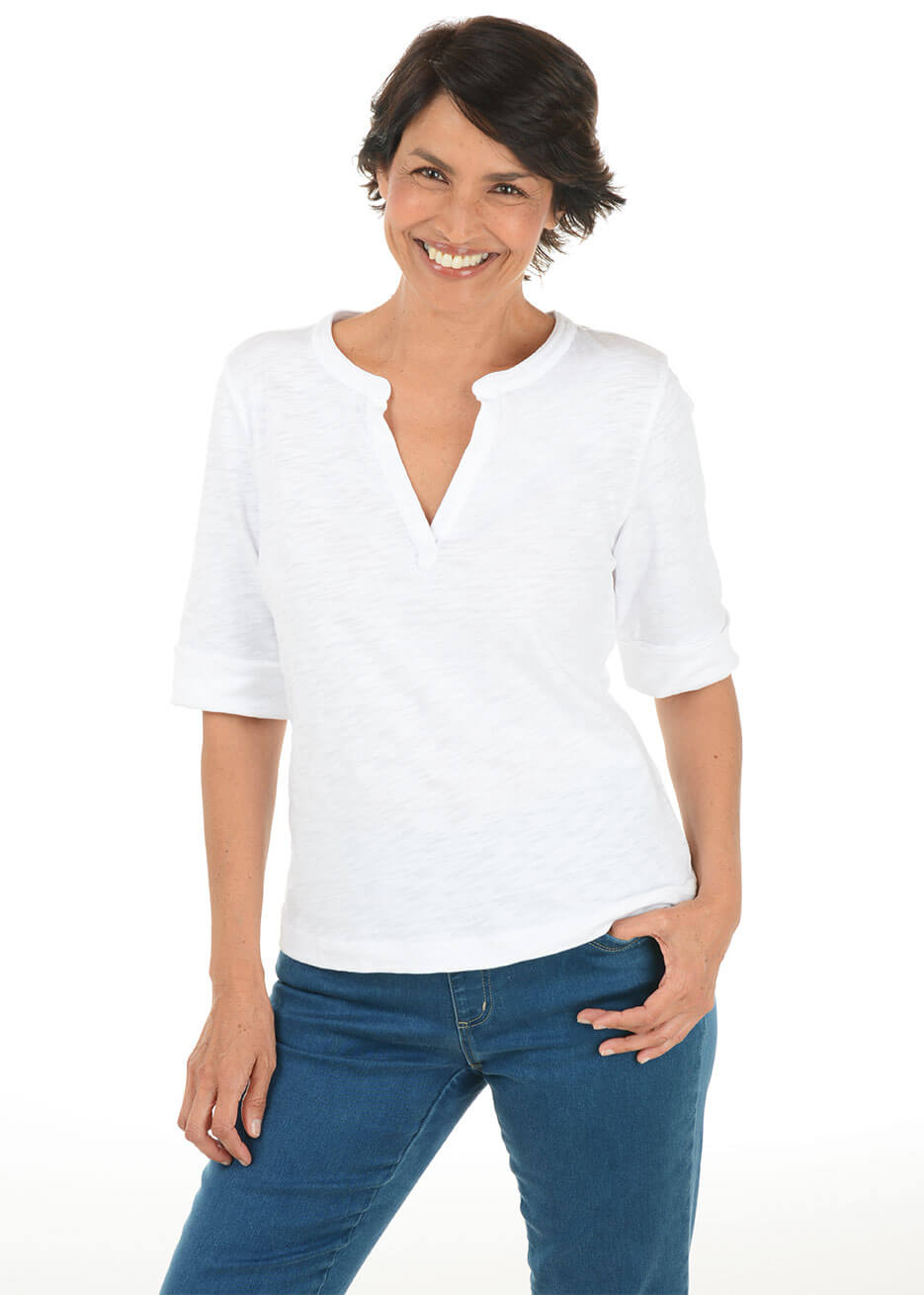 Woman wearing a white shirt and blue jeans on a white background