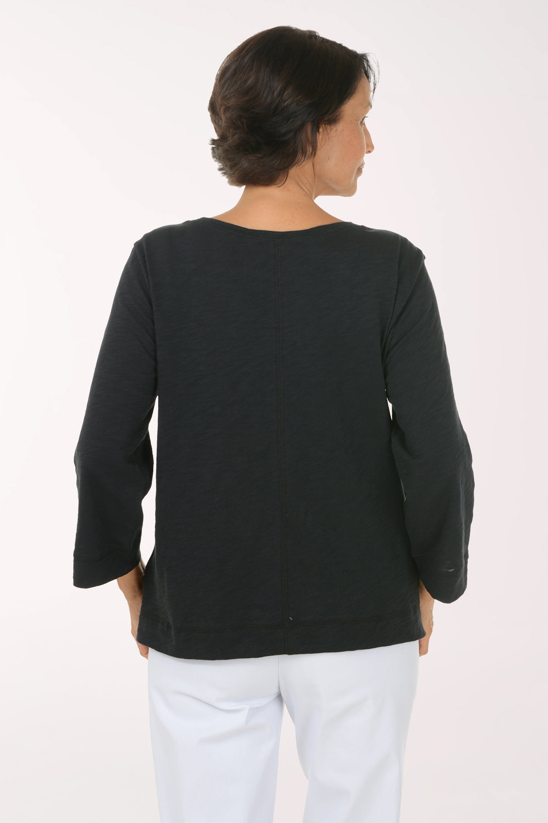 Woman wearing a black 3/4 sleeve boat neck top