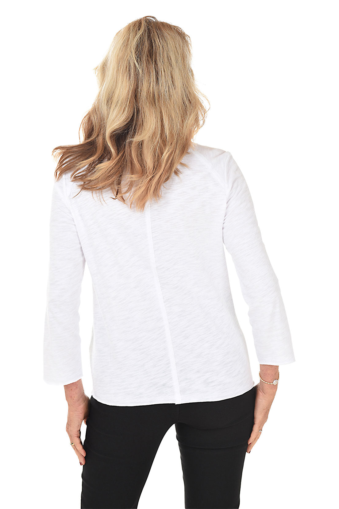 A back shot of a model wearing a white button-front cardigan with long sleeves and a foldover collar.