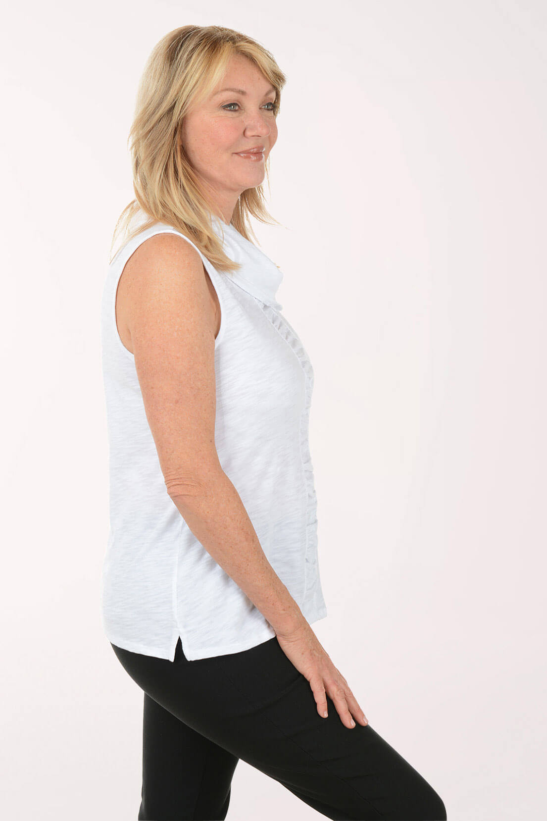 Woman wearing a white sleeveless top with a cowl neckline on a white background