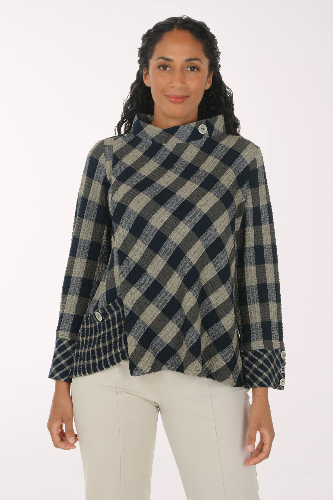 Woman wearing a black and white plaid mock neck top
