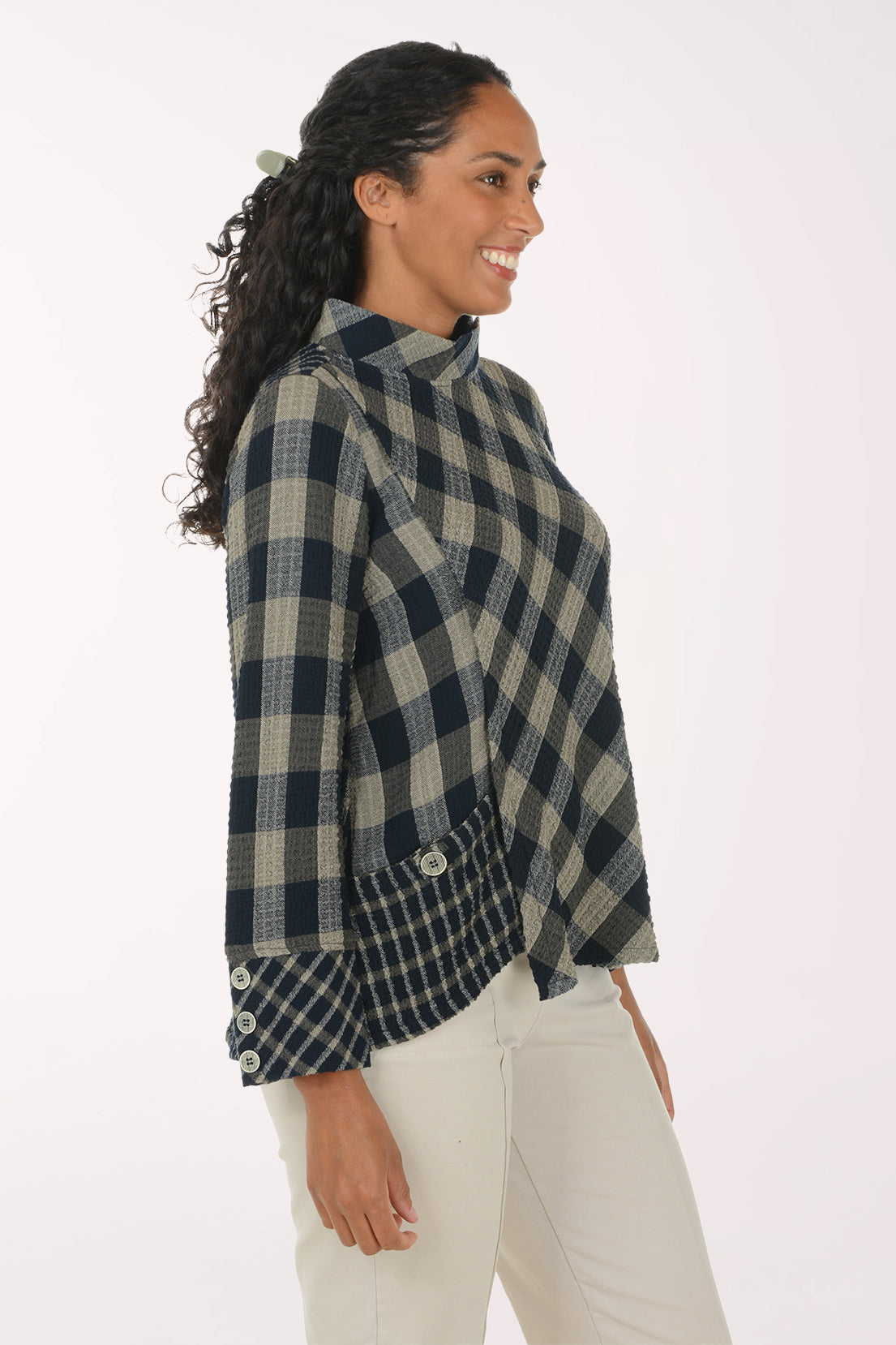 Woman wearing a black and white plaid mock neck top