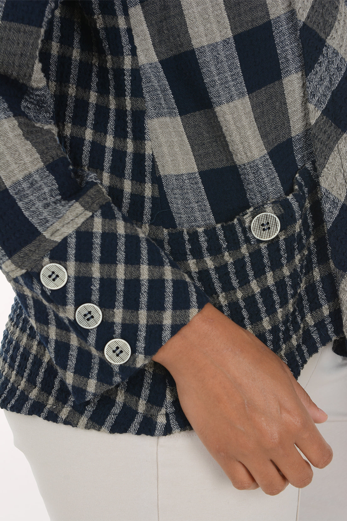 Woman wearing a black and white plaid mock neck top
