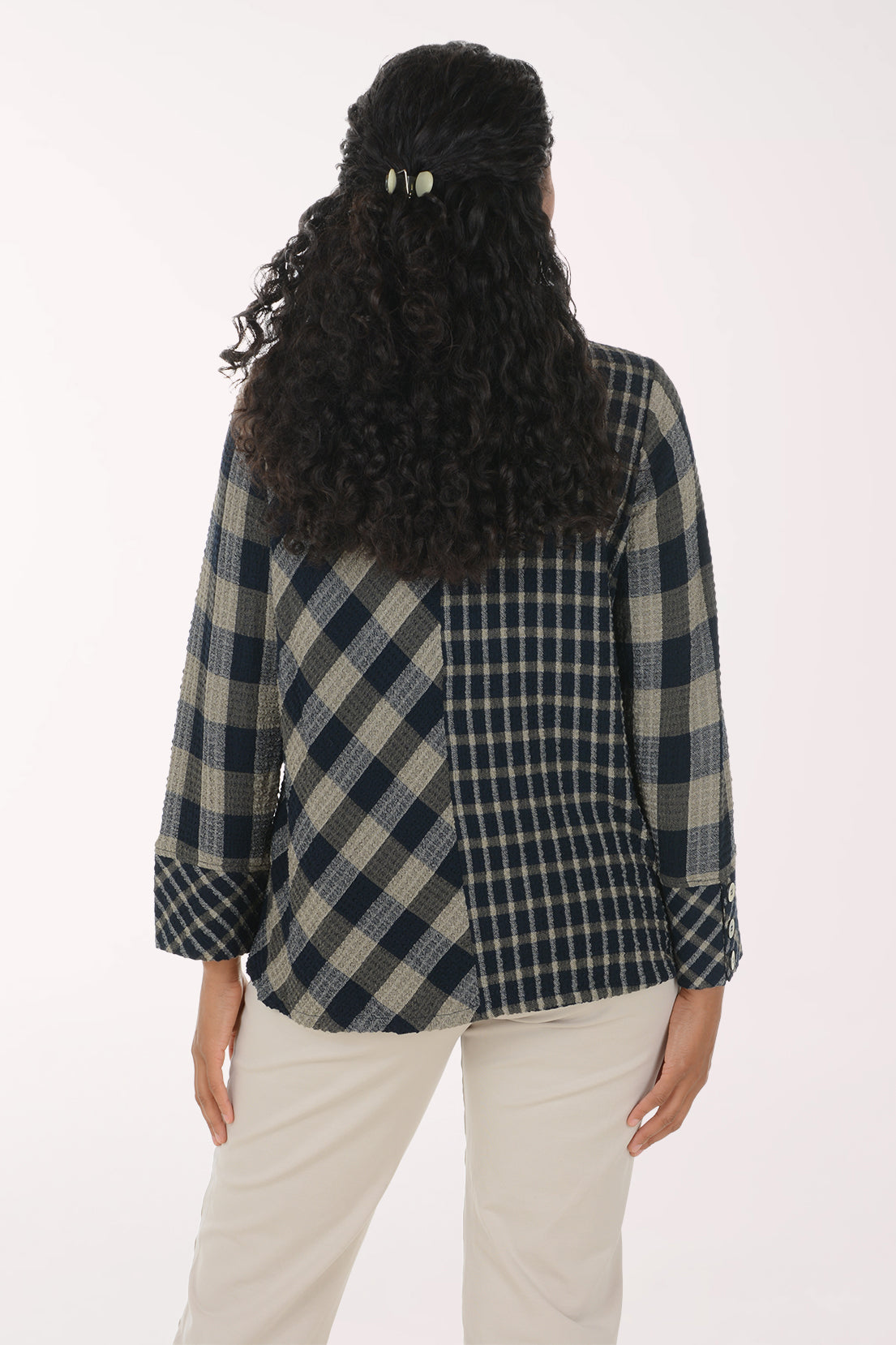 Woman wearing a black and white plaid mock neck top