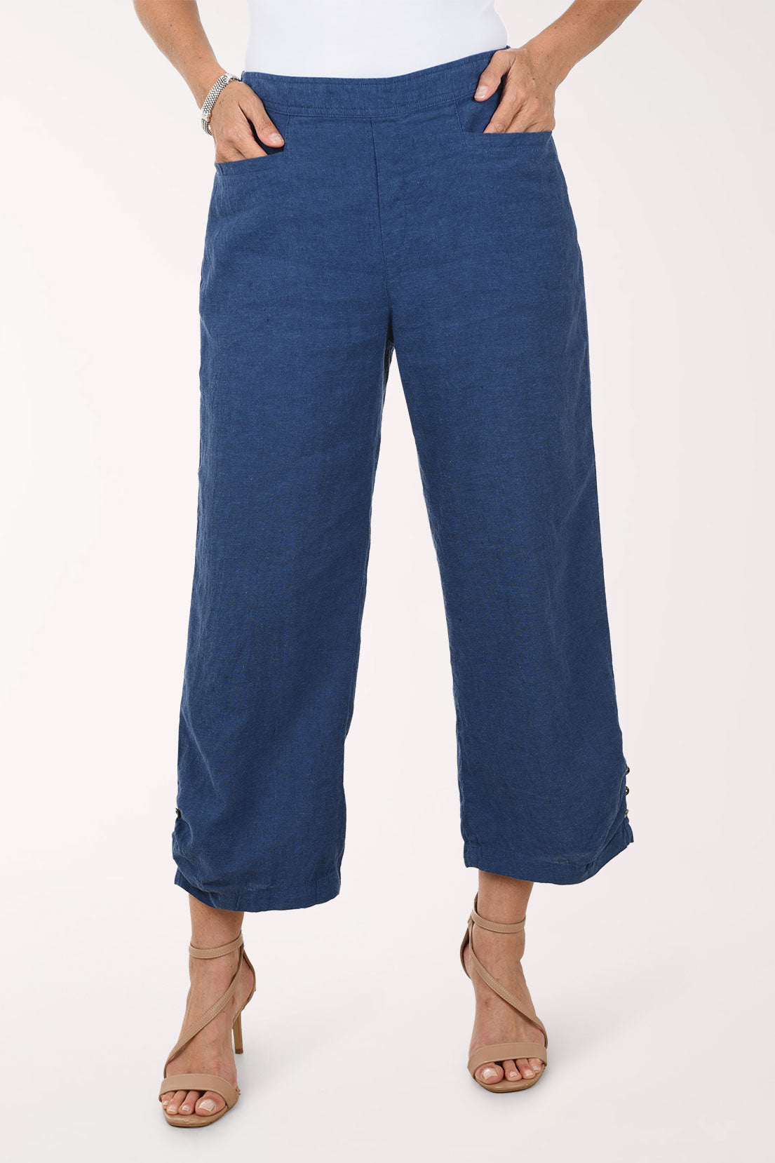 Blue pants worn by a person on a white background
