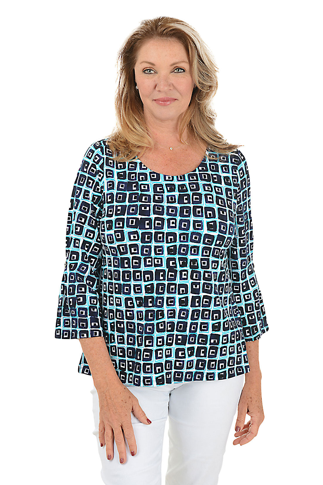 A front shot of a model wearing a navy and white geometric patterned top with a scoop neck and 3/4 bell sleeves with pleated button detail.
