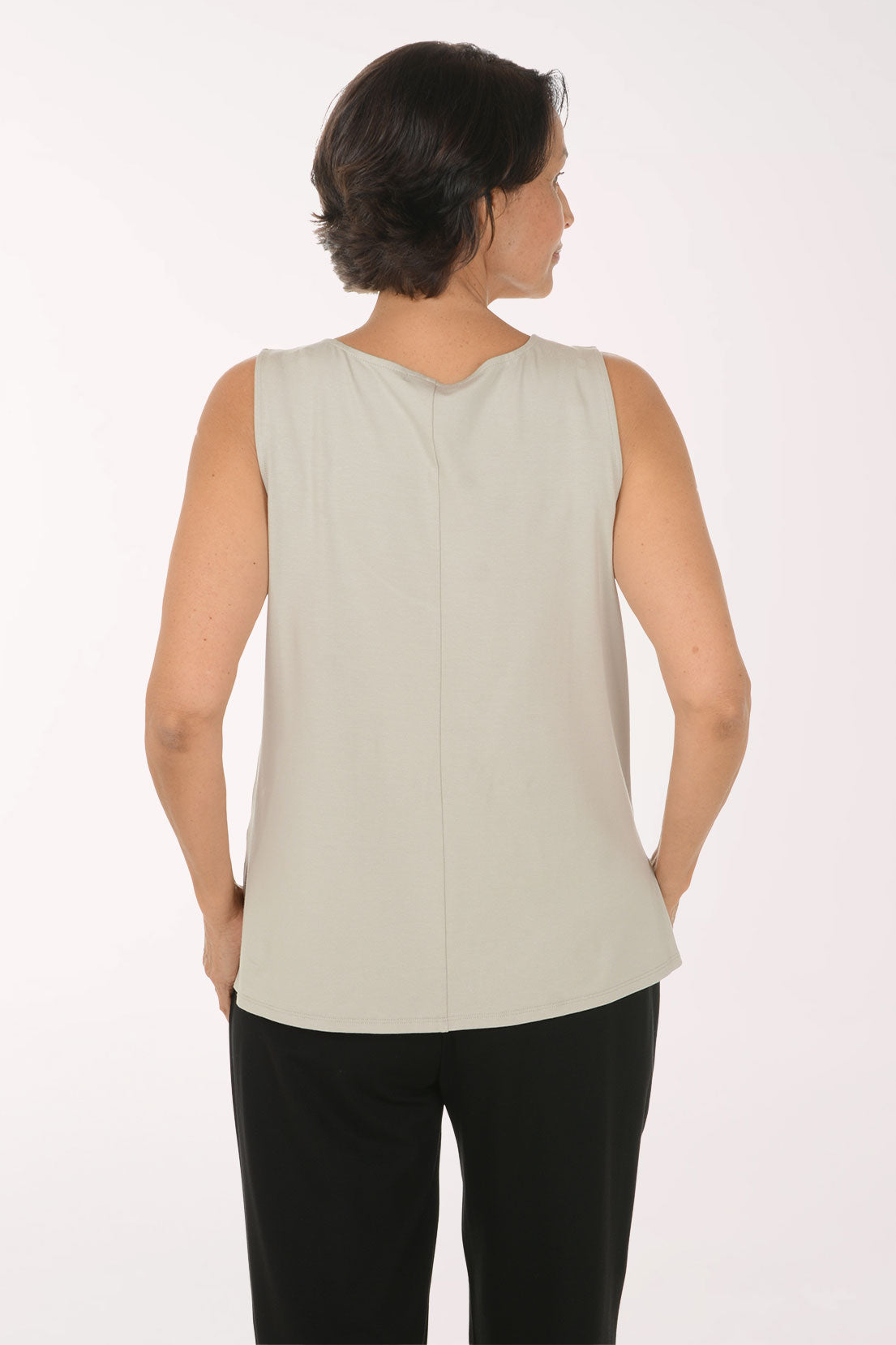 Woman wearing a solid beige tank top