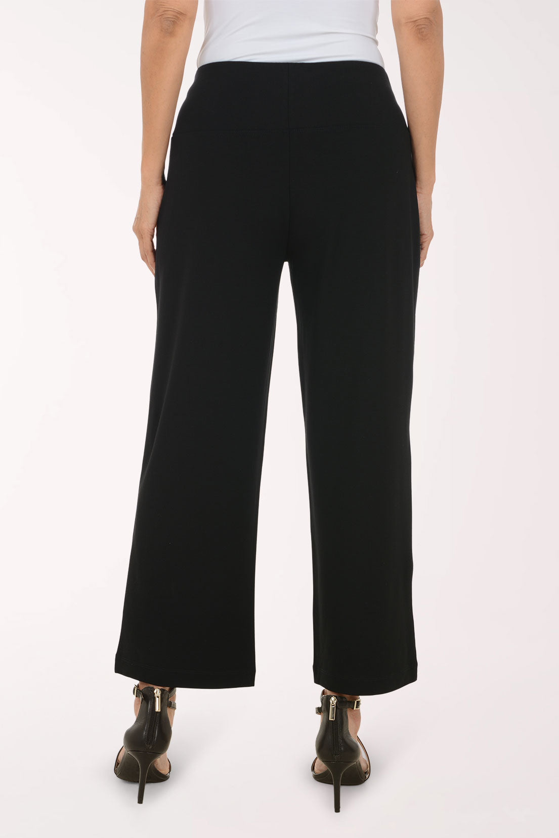 Woman wearing black full length pants